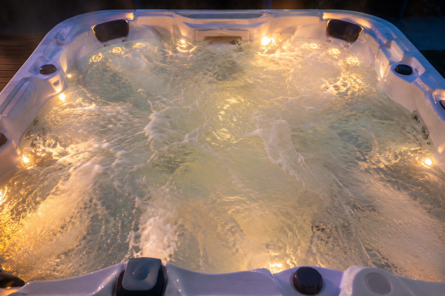 Hot tub with illuminated interior and water bubbles